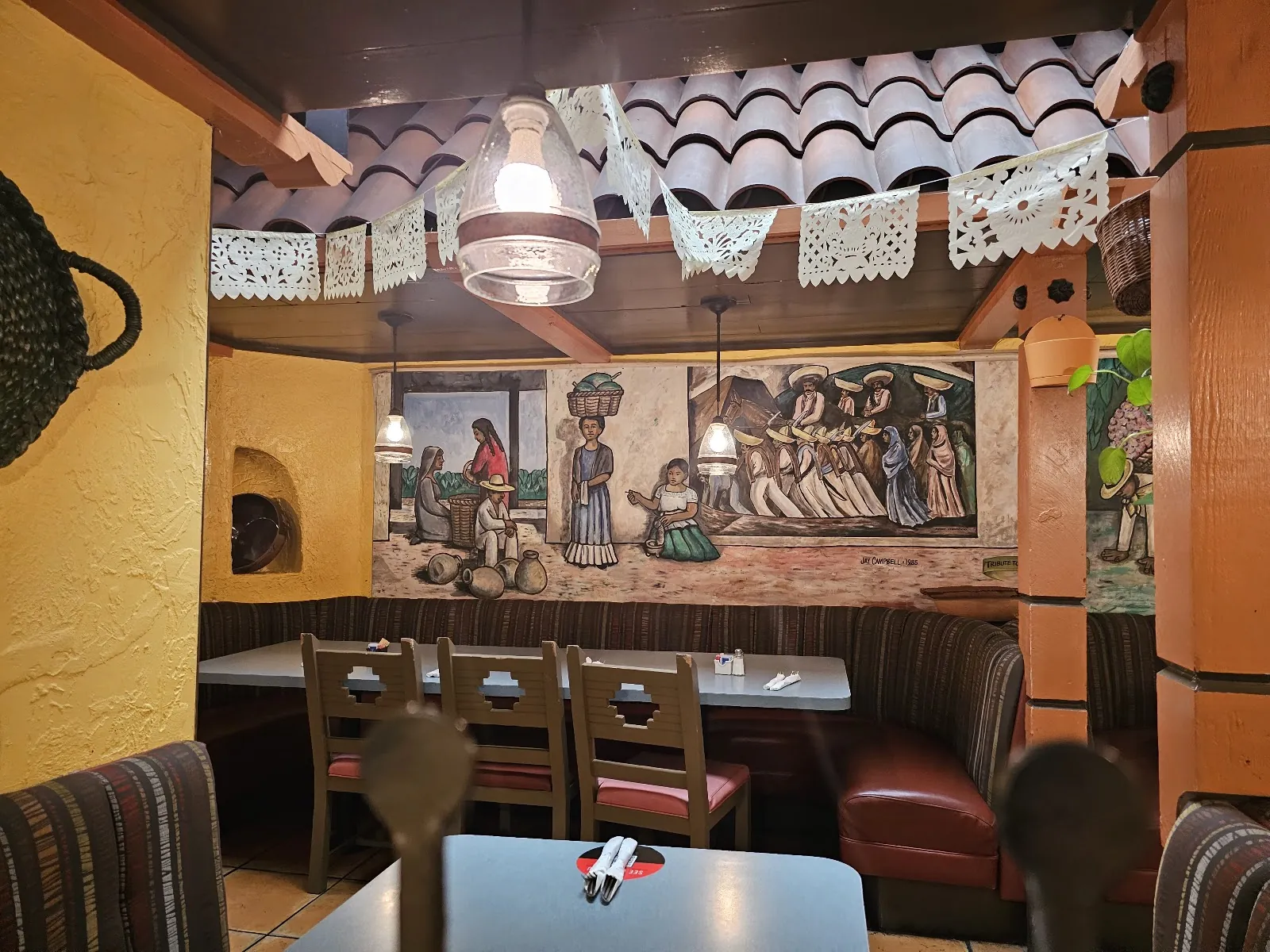 Booths beside a painted mural